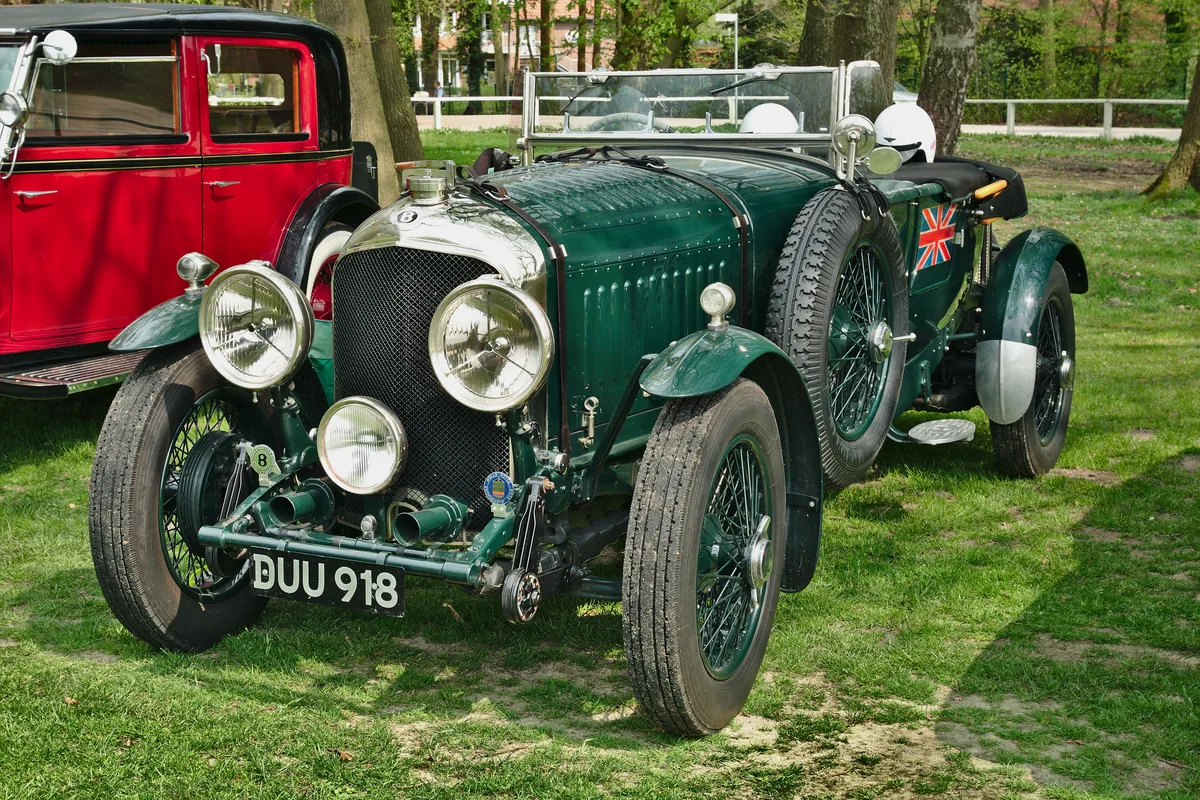 A green 1937 Bentley 4¼ Litre roadster with period headlamps