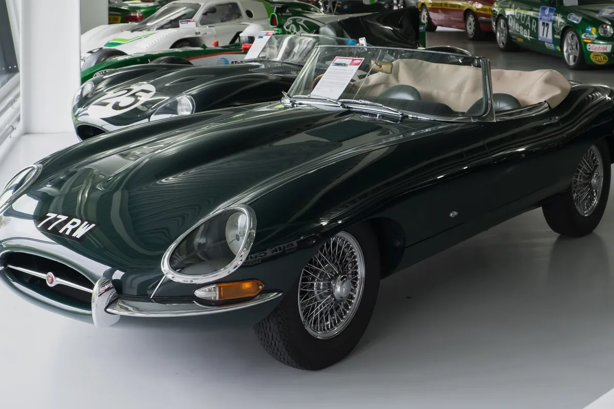 A dark green 1961 Jaguar E-Type Series 1 roadster