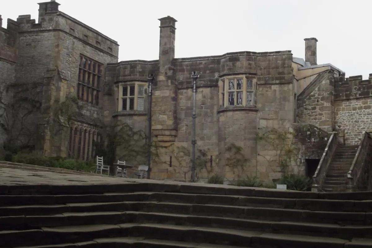 The weathered stone walls, chimneys and mullioned windows of the lower courtyard at Haddon Hall