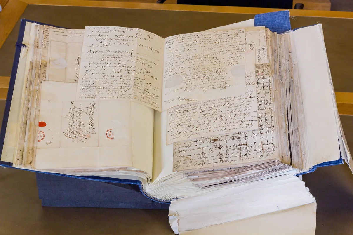 Bound volumes of handwritten nineteenth-century letters laid open in an archive