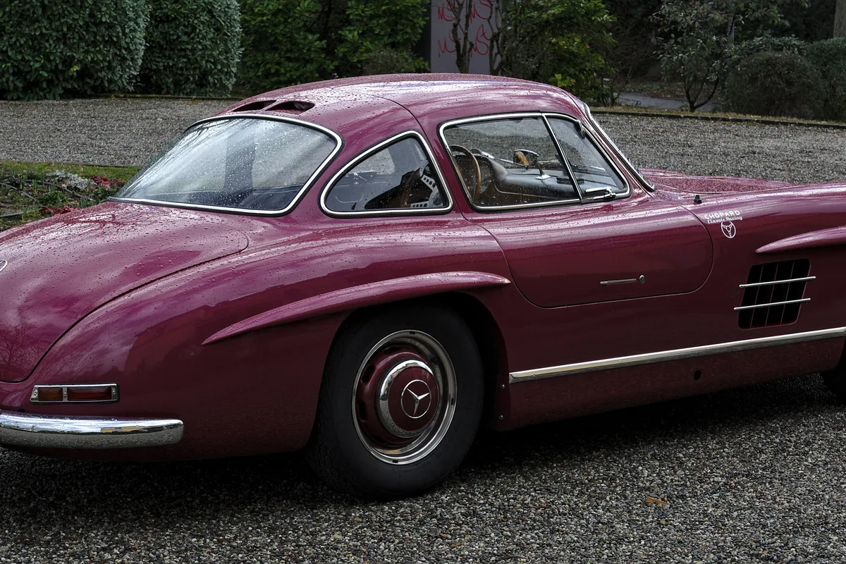 A burgundy Mercedes-Benz 300 SL Gullwing coupé