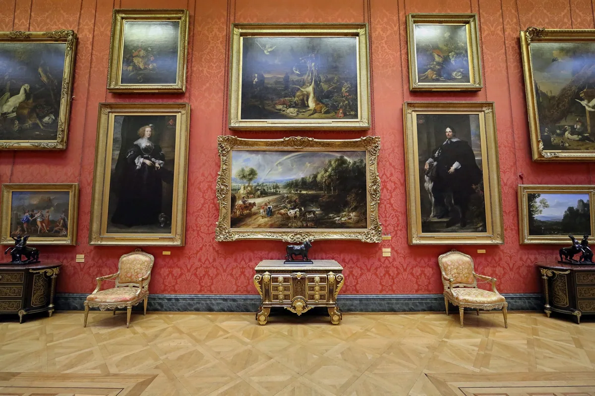Old Master paintings on red damask walls in the Great Gallery of the Wallace Collection